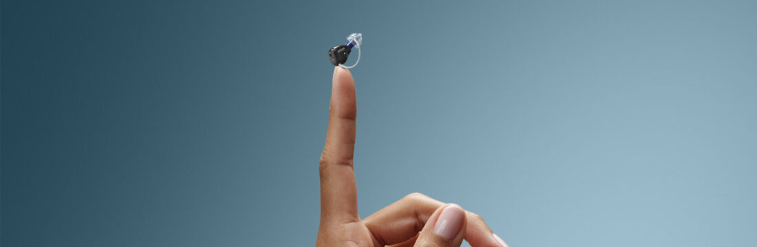 invisible hearing aids in Thunder Bay finger holding up a zeal hearing aid