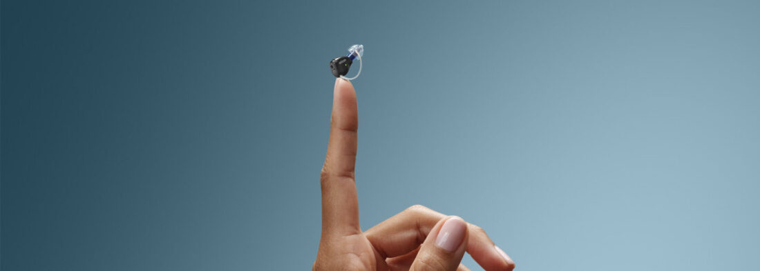 invisible hearing aids in Thunder Bay finger holding up a zeal hearing aid