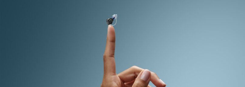 invisible hearing aids in Thunder Bay finger holding up a zeal hearing aid
